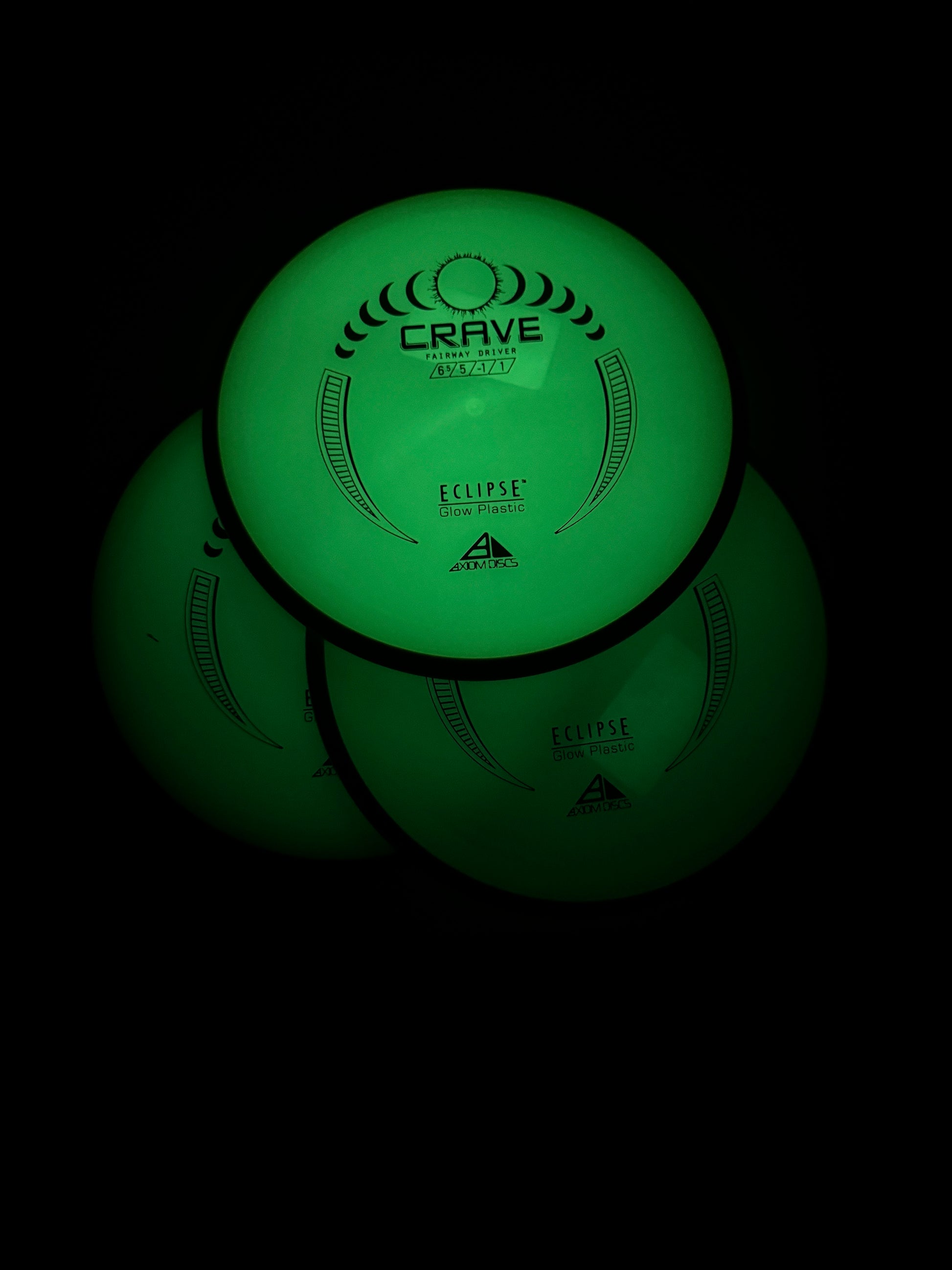 Three green discs with branding on a black background